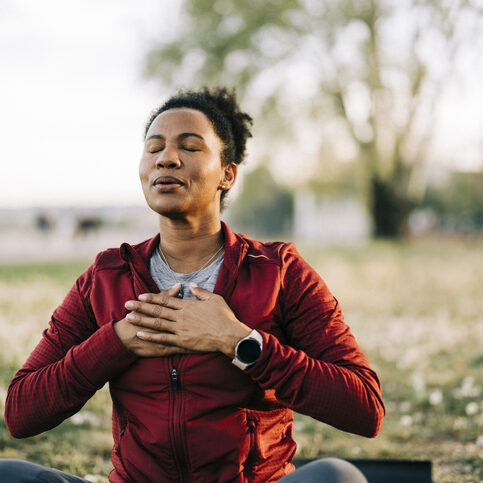Wellness, Black woman, breath and hand on chest, for meditation and wellness being peaceful to relax. Bokeh, African American female and lady outdoor, in nature and being calm for breathing exercise and health